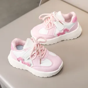 Pink and white children's chunky sneakers with velcro straps and thick soles