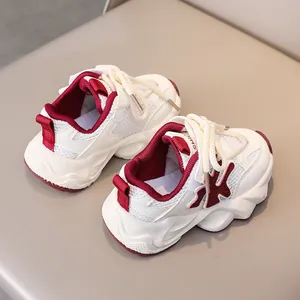 Detail of kids breathable mesh sneaker with white and burgundy paneling and thick sole