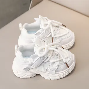 Close-up of white mesh girls sneakers featuring bow velcro strap and chunky nonslip sole