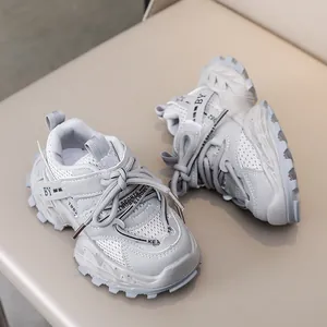 Detail view of grey kids running shoes with breathable mesh and anti-slip thick soles
