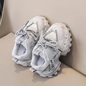 Detailed macro view of children's grey sneakers with mesh fabric and thick rubber soles