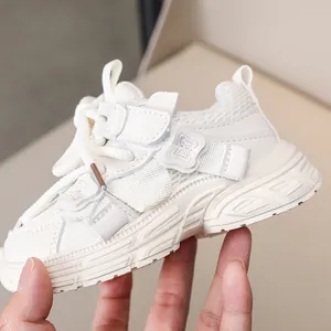 Close-up of white girls' running shoe featuring mesh texture and butterfly appliqué detail
