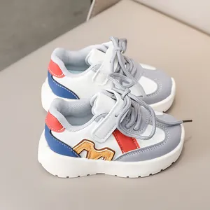 Detailed side view of children's sneakers with vibrant color stitching and velcro strap