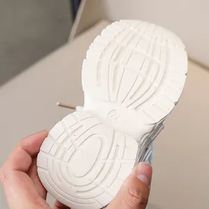 Detail of white anti-slip outsole with size 22 marking for kids sports shoes