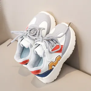 Detailed side view of colorful children sneakers with leather texture and thick rubber soles