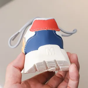 Detailed view of the multi-color leather heel design on children's sneakers with M logo