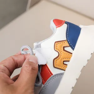 Close-up showing the adjustable velcro strap and laces on these colorful kids sneakers