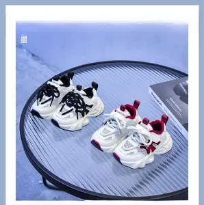 Close-up of breathable mesh kids sneakers in black-white and red-white on a glass table
