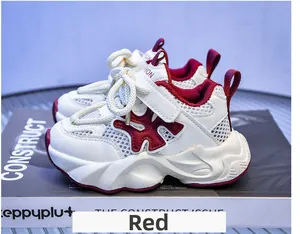 Detail view of breathable mesh upper and adjustable velcro strap on kids' red sneakers