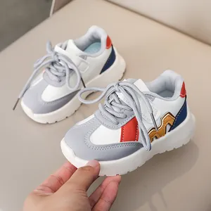 Kids minimalist white and grey leather sneakers with blue accents and wavy rubber sole