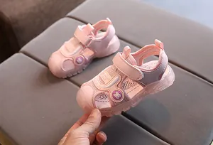 Detail of pink kids sandals with mesh fabric, toe protection and spider design
