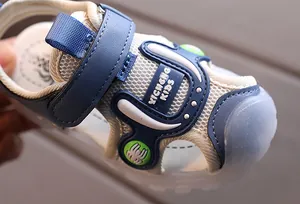 Detail of blue children's sandals showing breathable mesh and rubber toe cap