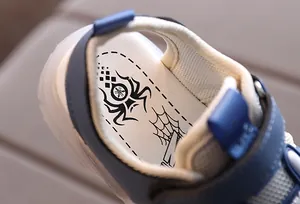 Detail view of children's sandals showing spider pattern insole and padded heel tab