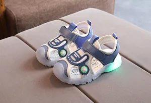 Detail of children's mesh sandals with protective toe cap and glowing LED spider motif