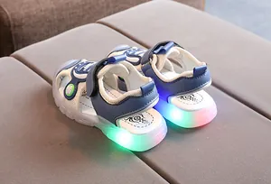 Detail of kids LED sandals with blue mesh upper and glowing transparent rubber soles