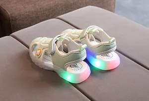 Detail view of children's mint green sports sandals with glowing LED lights on soft soles