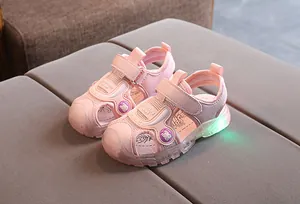 Detail view of pink kids sandals with LED glowing sole and breathable mesh upper