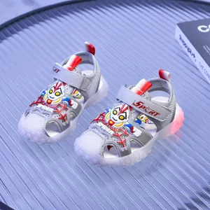 Detail of kids mesh sandals with closed toe design and glowing LED red lights on the sole