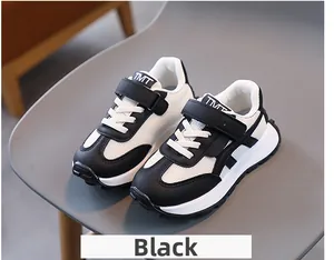 Close-up of kids black and white sneakers with mesh fabric and velcro closure