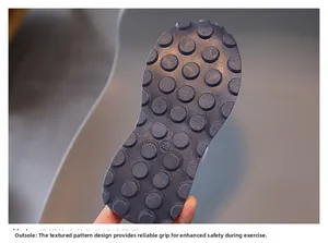 Close-up of size 28 kids sneakers outsole with non-slip circular grip pattern