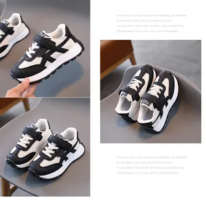 Kids' black and white mesh sports sneakers with velcro straps and anti-slip rubber soles