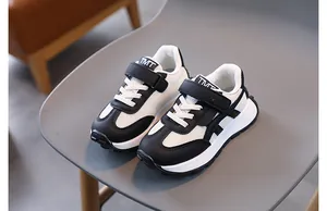 Close-up of kids' black and white mesh sports shoes with hook and loop strap closure