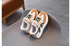 Detail of children's mesh sneakers featuring beige mesh and brown rubber lug sole
