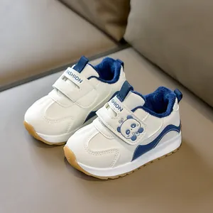 Blue and white plush-lined baby sneakers with cute panda patch and velcro straps