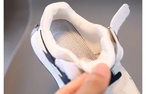 Close-up of children sneakers showing breathable striped insole and soft padded heel lining