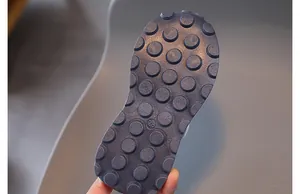 Detail of size 28 dark blue rubber sole with dense anti-slip lugs on kids sneakers