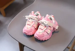Detail of pink and white kids chunky sneakers with velcro straps and anti-slip soles