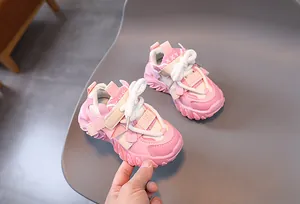 Detail of pink toddler sneakers showing adjustable velcro straps and cushioned thick soles