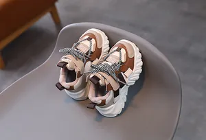 Top view of kids chunky sneakers featuring beige and brown patchwork with velcro straps