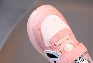 Close-up of pink toddler sneakers with cartoon detail and perforated breathable toe cap
