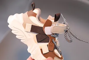 Detail of kids chunky sneaker with leather upper and velcro strap closure