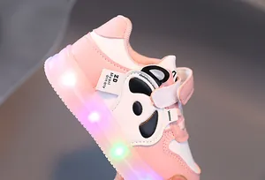 Close-up of pink panda toddler shoes with colorful LED light-up soles and velcro straps