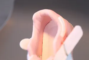 Detail of pink toddler shoe featuring breathable mesh lining and padded heel support