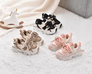 Detailed view of plush-lined kids sneakers in black, beige and pink for winter comfort