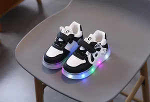 Close-up of cute panda cartoon character and colorful LED glowing lights on children's shoes