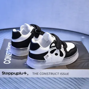 Detail of baby panda sneakers featuring convenient hook and loop straps and soft anti-slip soles