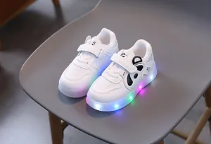 Detail of LED light-up sole with colorful RGB glowing effect on toddler panda sneakers