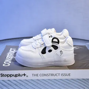 Detail of white toddler LED shoes with panda motif and velcro strap on soft sole