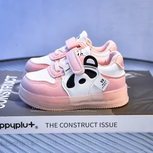 Detail of pink toddler shoes with panda patch and secure velcro strap on magazine base