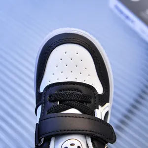 Detailed macro view of toddler sneakers featuring breathable toe holes and velcro strap