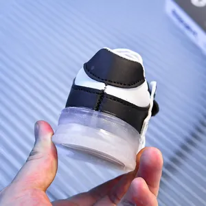 Close-up of baby sneaker showing the translucent non-slip sole and hook-and-loop closure