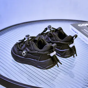 Détails de basket enfant en mesh respirant avec laçage rapide et logo visage souriant