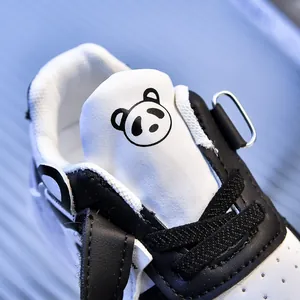 Close-up of baby sneaker leather texture with cute panda cartoon motif and black laces