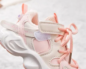 Close-up of pink children's fleece sneaker featuring plush lining and mesh details