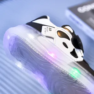 Close-up of toddler LED glowing sneakers showing pink and green lights on thick soles