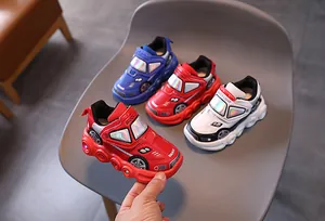 Detail of light-up kids sports sneakers with race car design and LED glowing soles